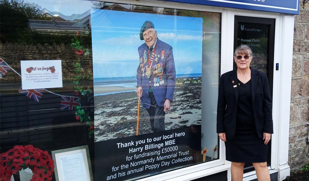 Personal Choice Funeral Directors Remembrance Day window display for their St Austell, Alexandra Road branch. There is an image in the window showing local hero Harry Billinge MBE and thanking him for fundraising £50,000 for the Normandy Memorial Trust and his annual poppy day collection.